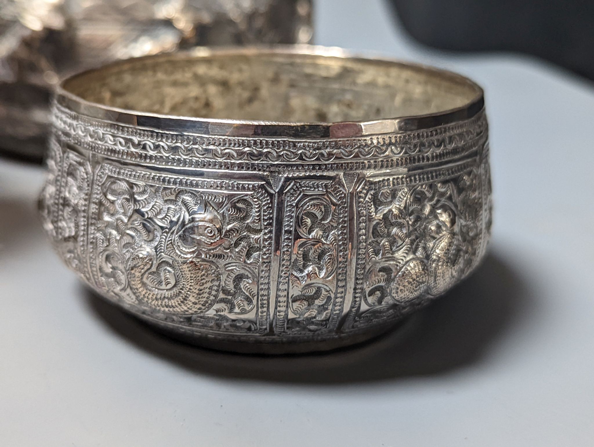 Six assorted embossed white metal bowls, including Indian and Thai, tallest 13.6cm.